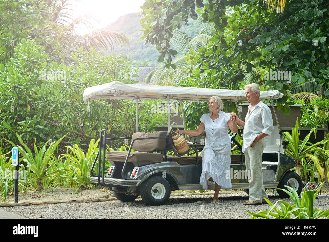 Elderly couple  in tropical garden Stock Photo