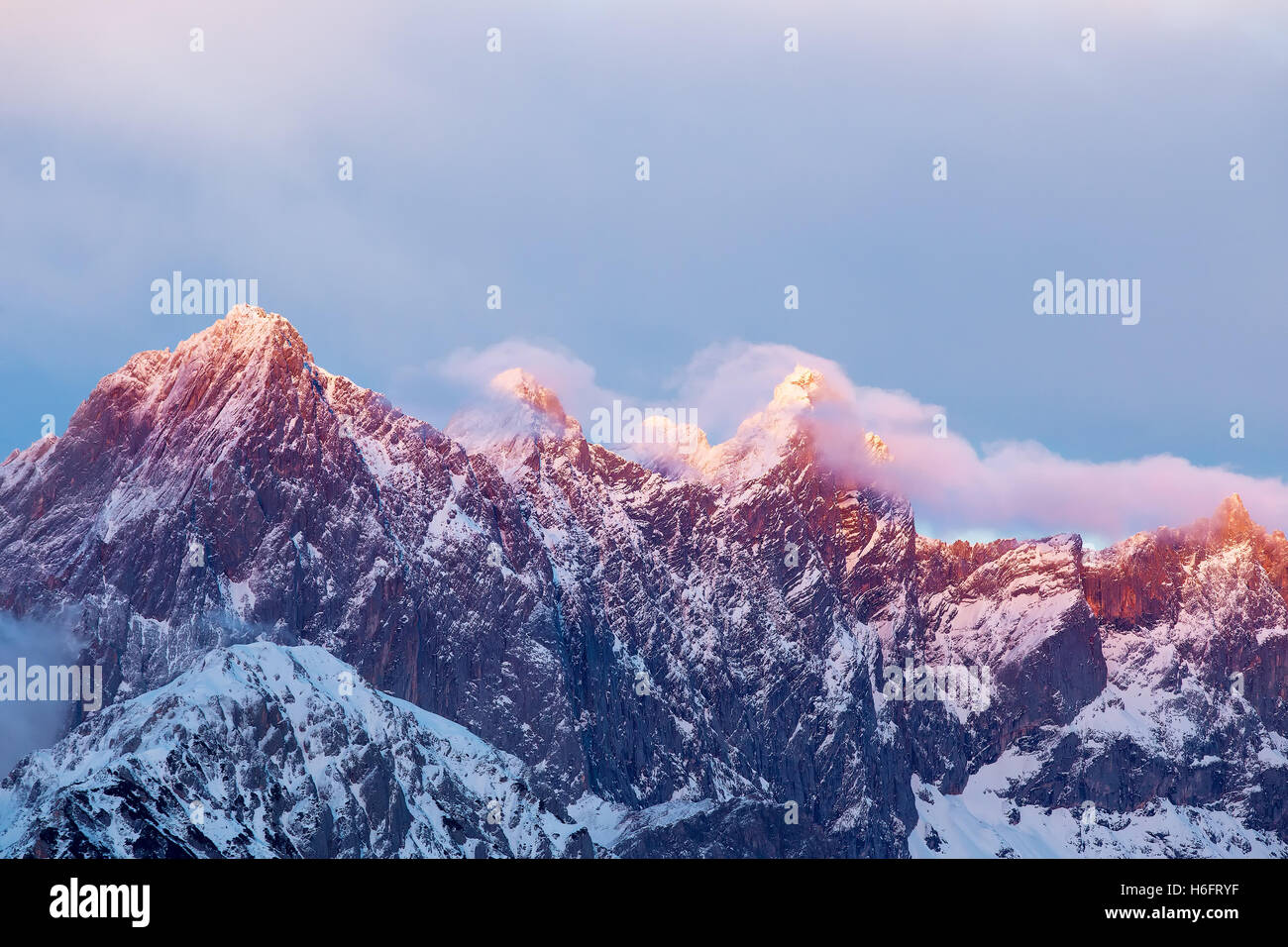 Alpen glow in the middle of winter on the rocky mountains of the Dachstein. Stock Photo