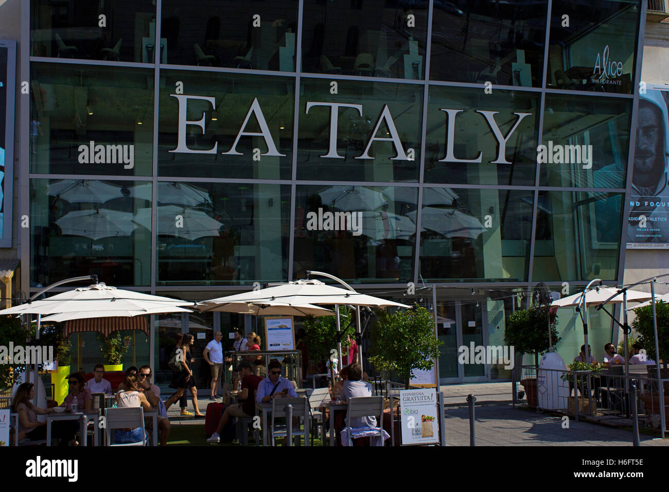 Milano Corso Como area: vision of Eataly Italian traditional restaurant  with glass facade and tables outside, sunshine Stock Photo - Alamy