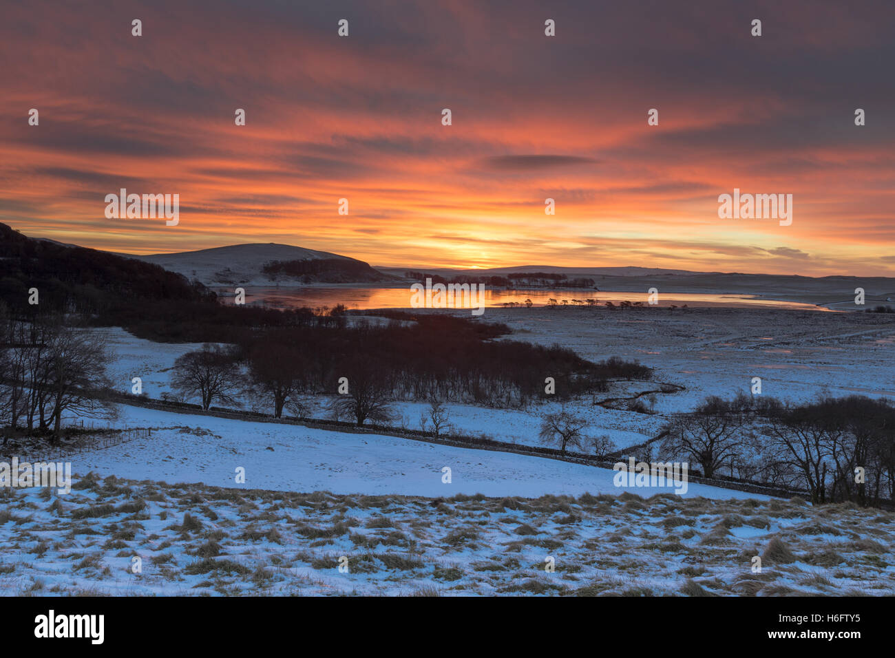 Dramatic winter sunrise over a frozen Malham Tarn in the Yorkshire Dales National Park, UK Stock Photo