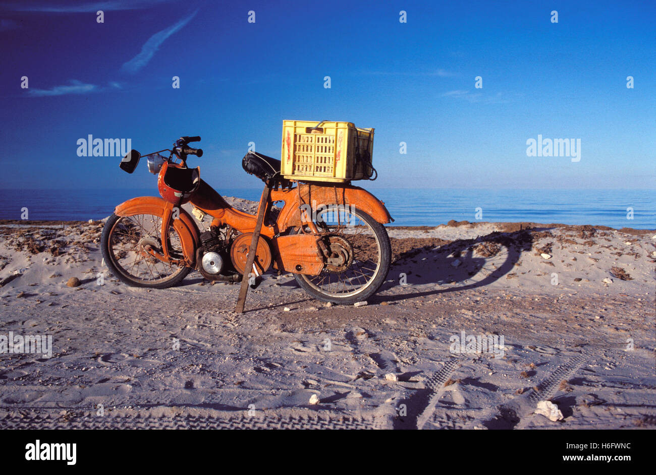 Tunisia, Jarbah Island, old moped at the Sidi Mahrez beach. Stock Photo