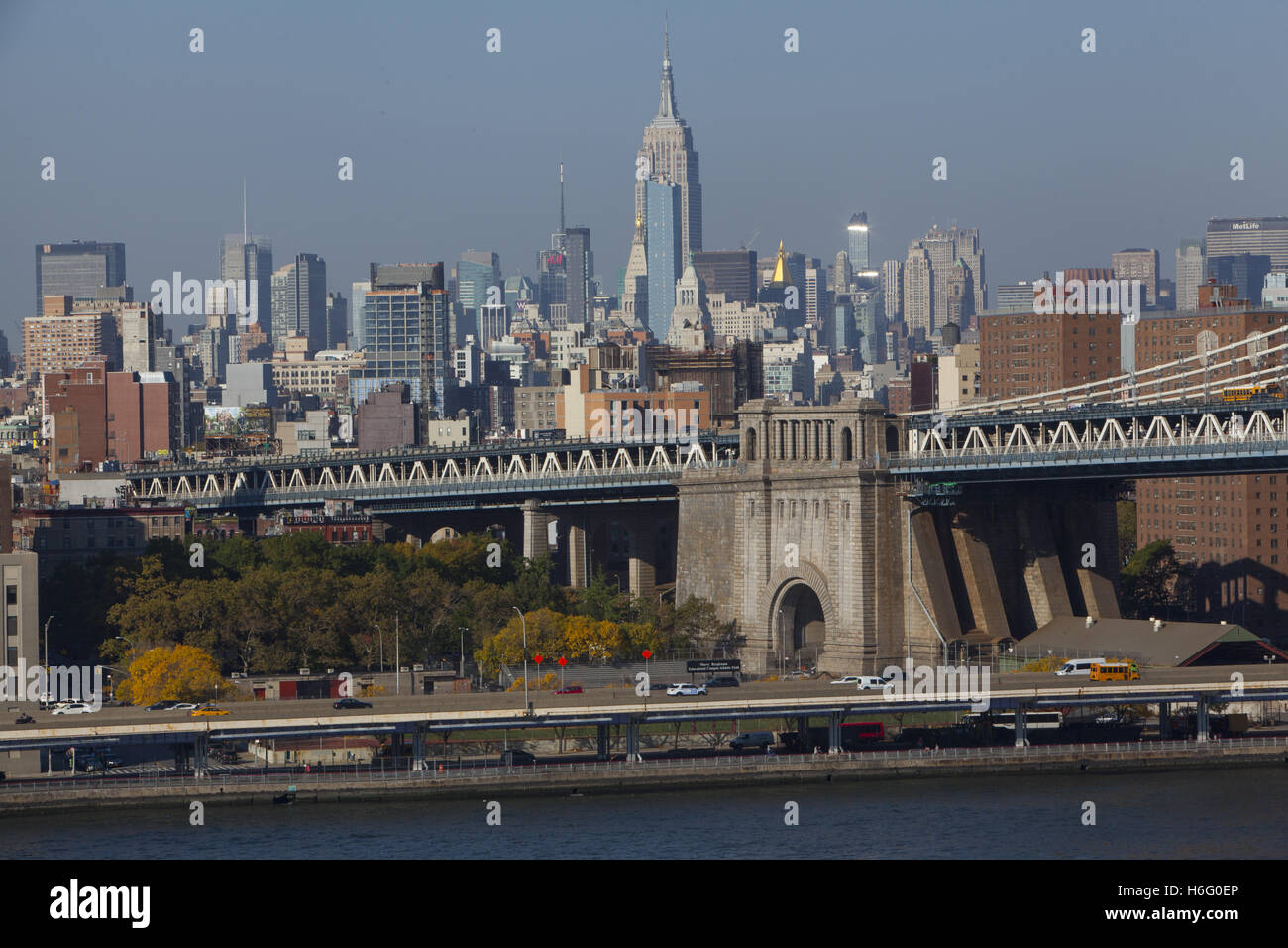 Manhattan Bridge in the foreground, looking north into midtown across the East River from the Brooklyn Bridge. Stock Photo