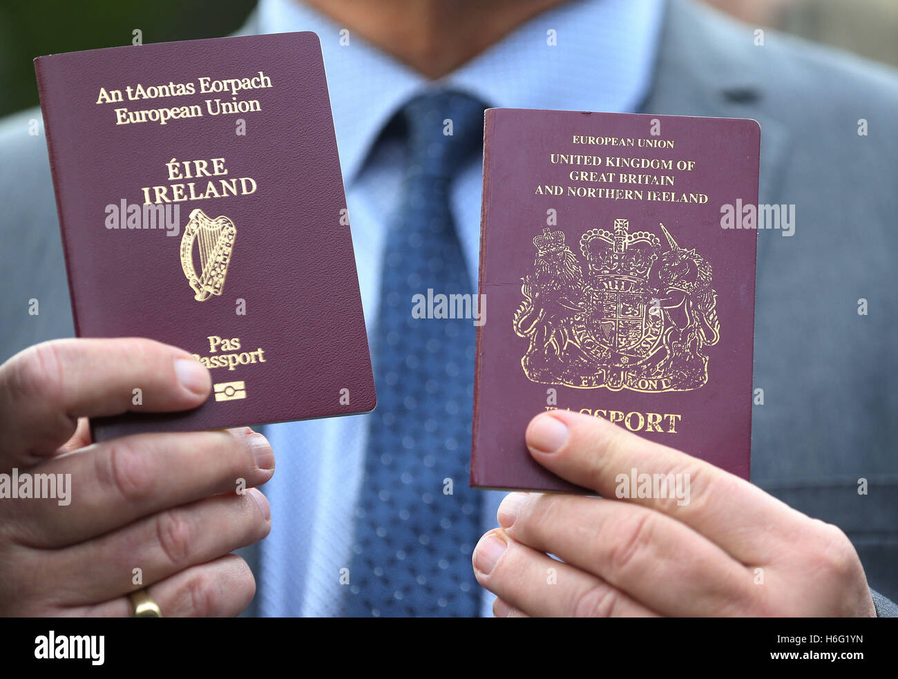 Raymond McCord holds up his newly issued Irish passport alongside his British passport outside the High Court in Belfast following a judges dismissal of the UK's first legal challenges to Brexit. Stock Photo