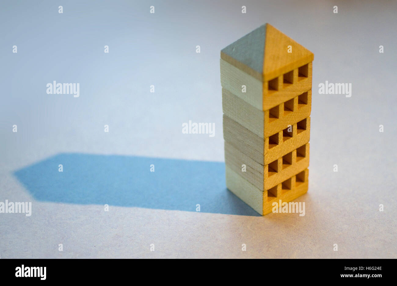 Wooden blocks representing a tower block like building. Stock Photo