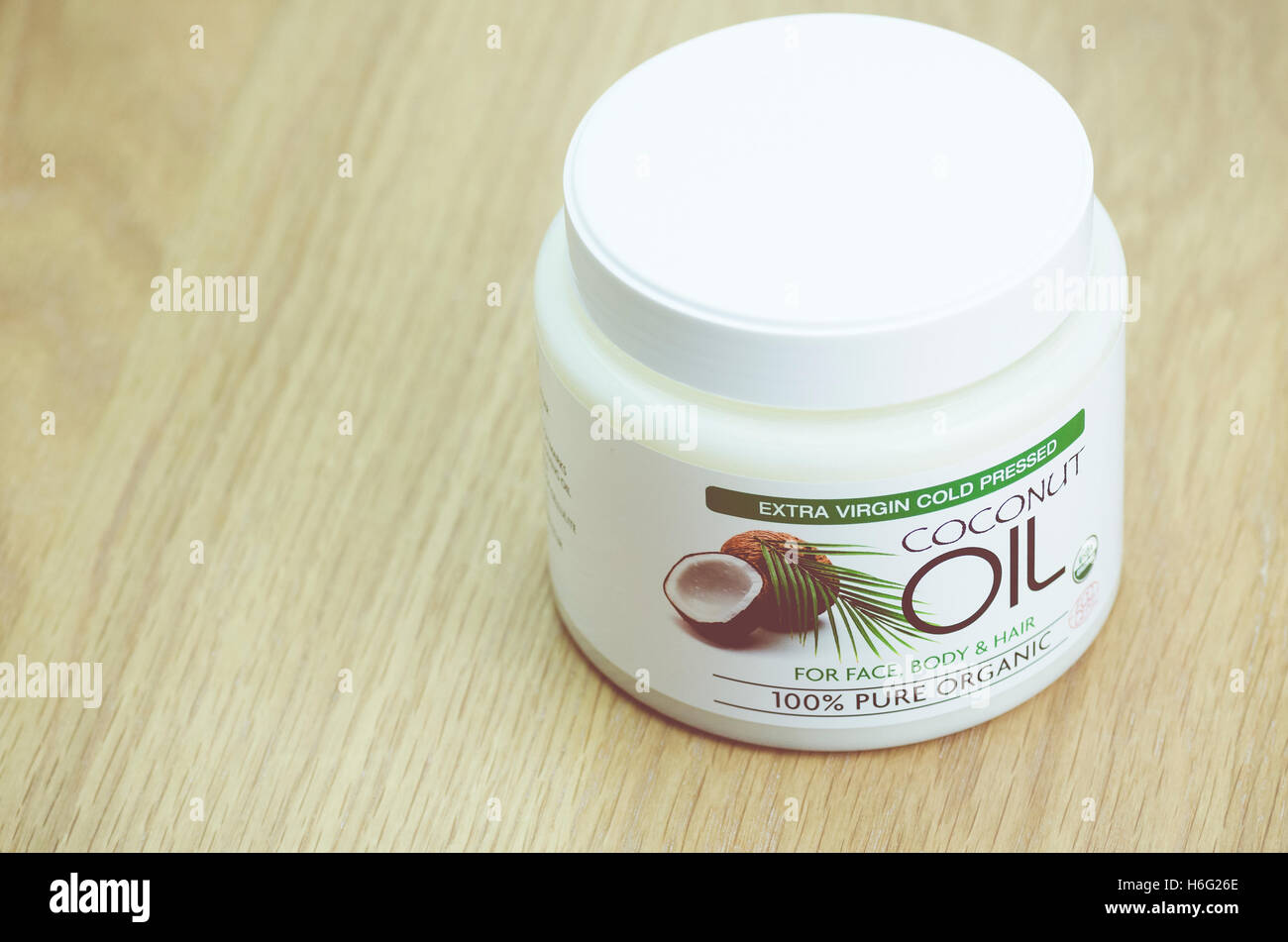 coconut oil butter in a white can on a wood surface healthy lifestyle