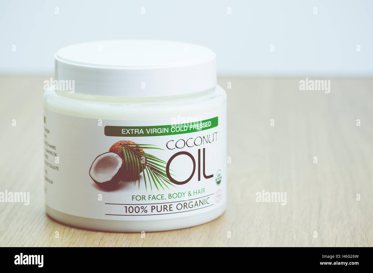 coconut oil butter in a white can on a wood surface healthy lifestyle