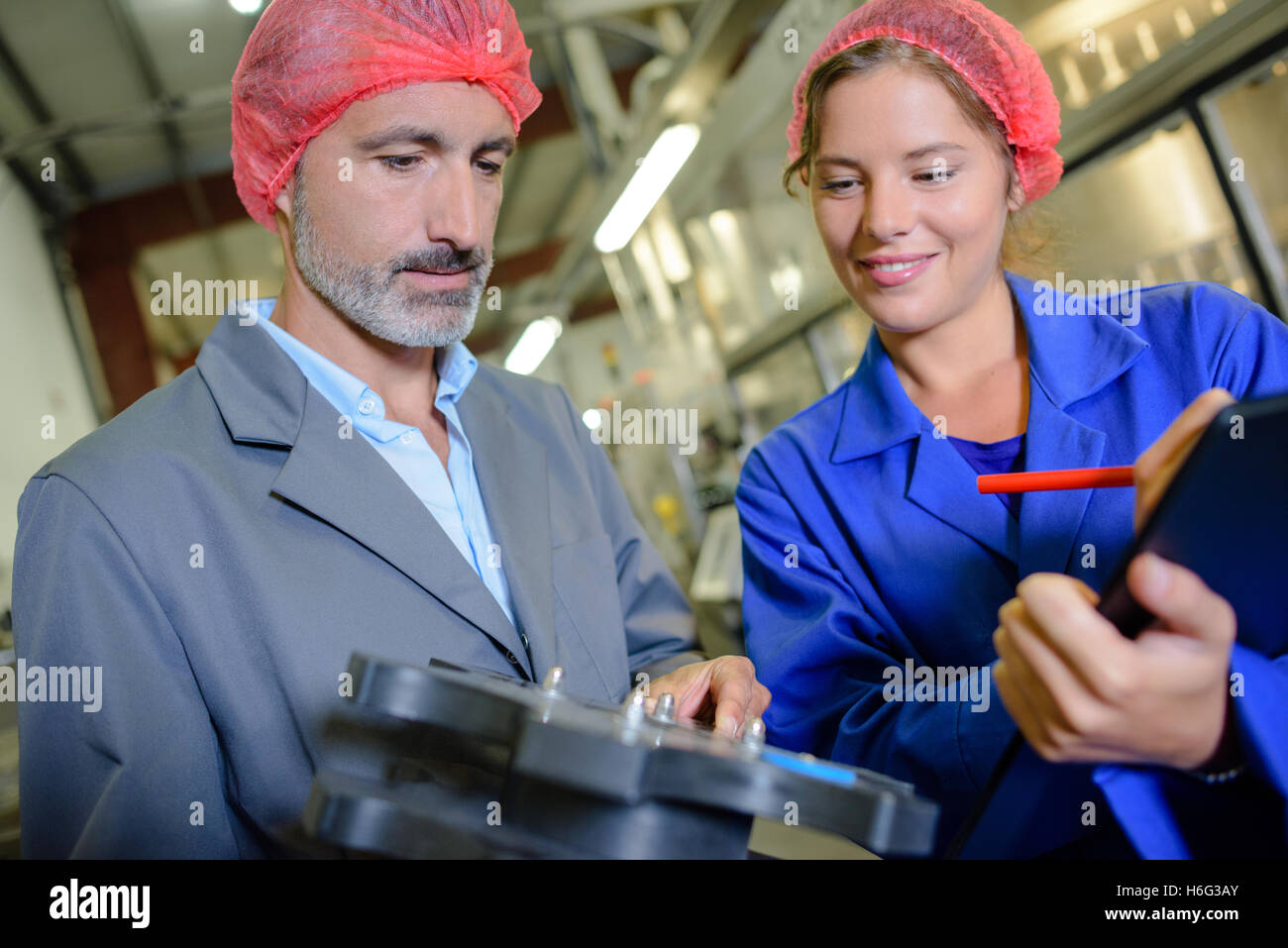 Female worker making notes on clipboard Stock Photo - Alamy