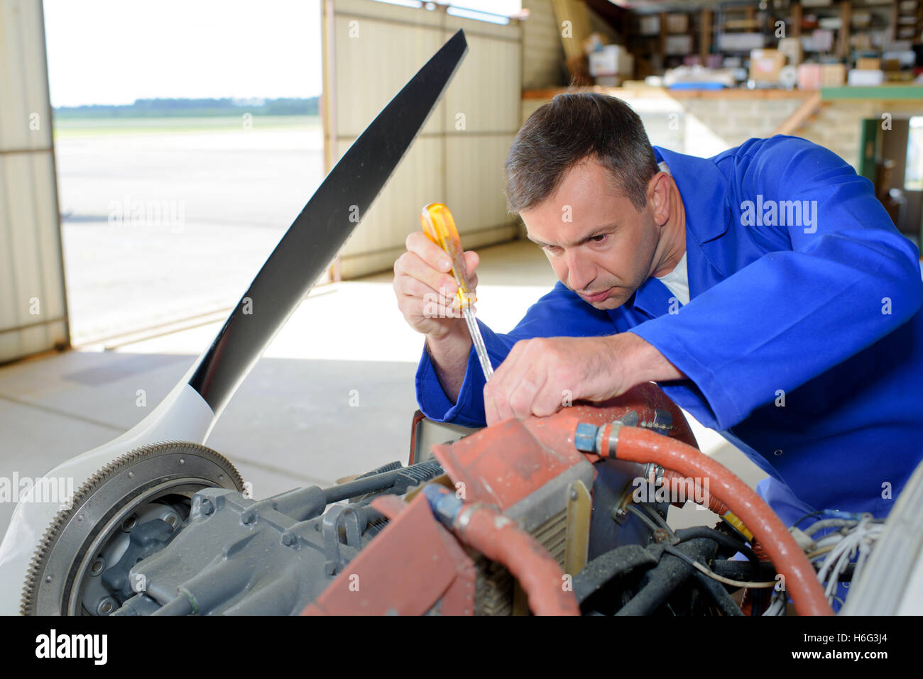 Mechanic working on aircraft Stock Photo