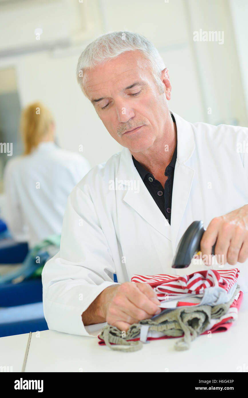 Man scanning garment Stock Photo - Alamy