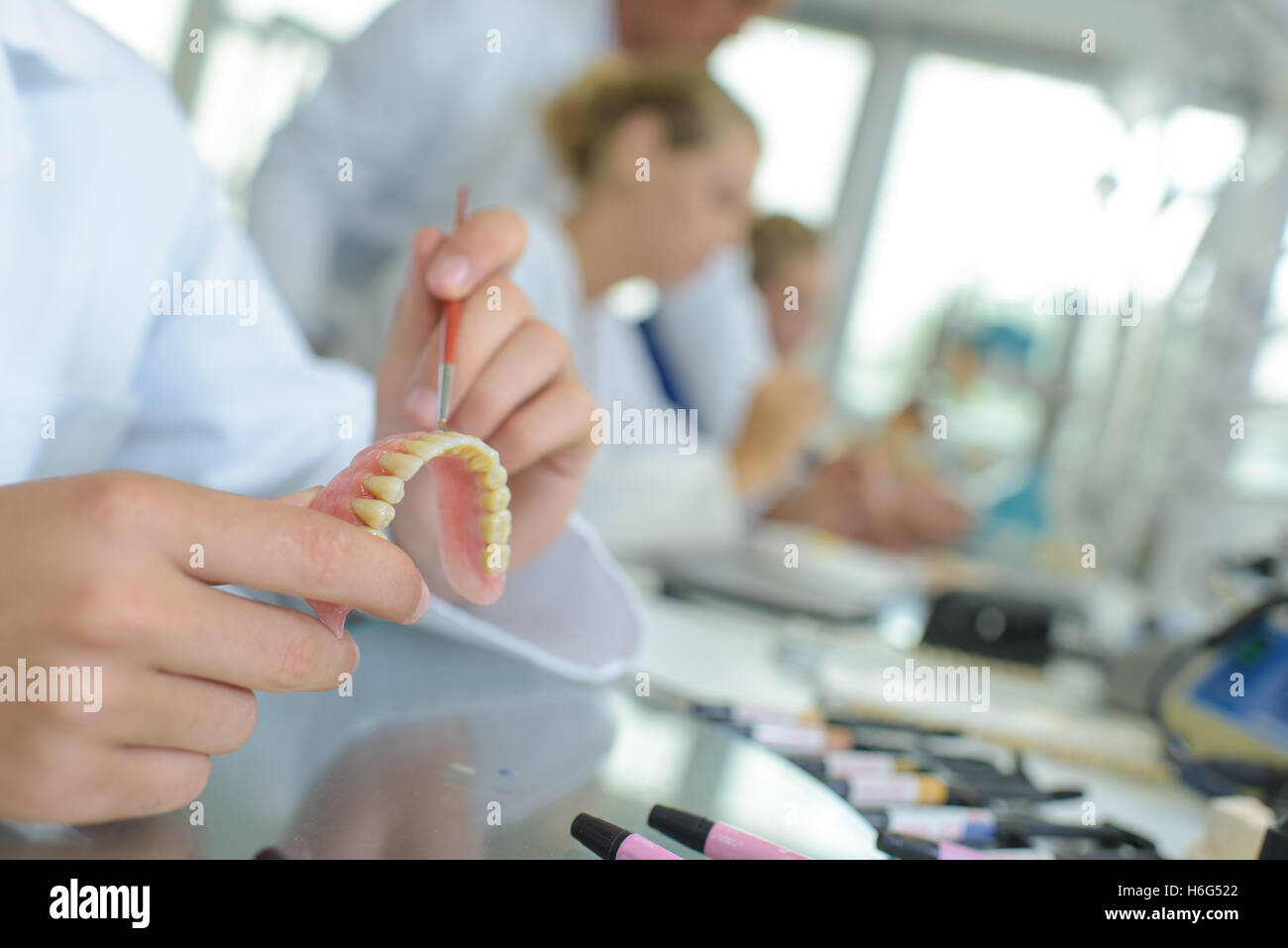 Person painting false teeth Stock Photo Alamy