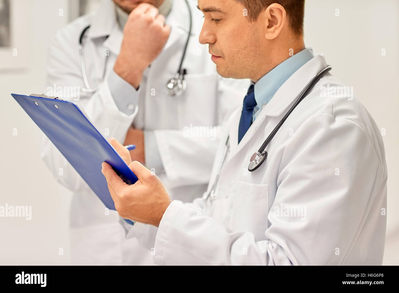 close up of doctors with clipboard at hospital Stock Photo - Alamy