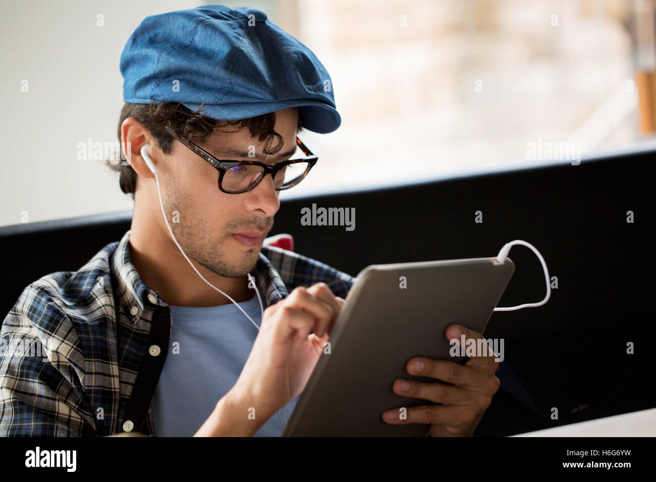 close up of man with tablet pc and earphones Stock Photo - Alamy