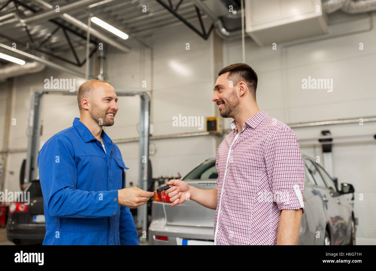 Mechanic giving car key man hi-res stock photography and images - Alamy