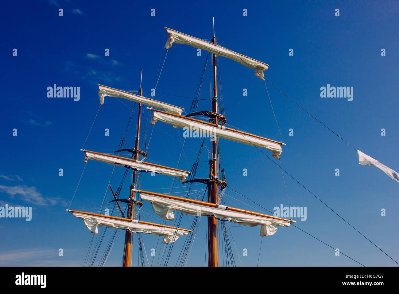 The masts of a ship against a blue sky Stock Photo - Alamy