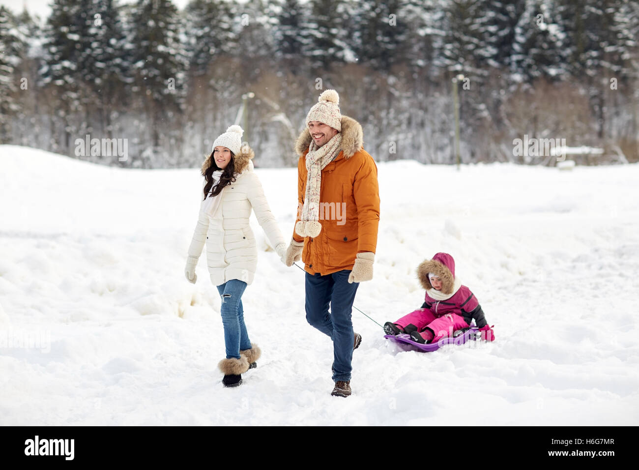 happy family with sled walking in winter forest Stock Photo - Alamy