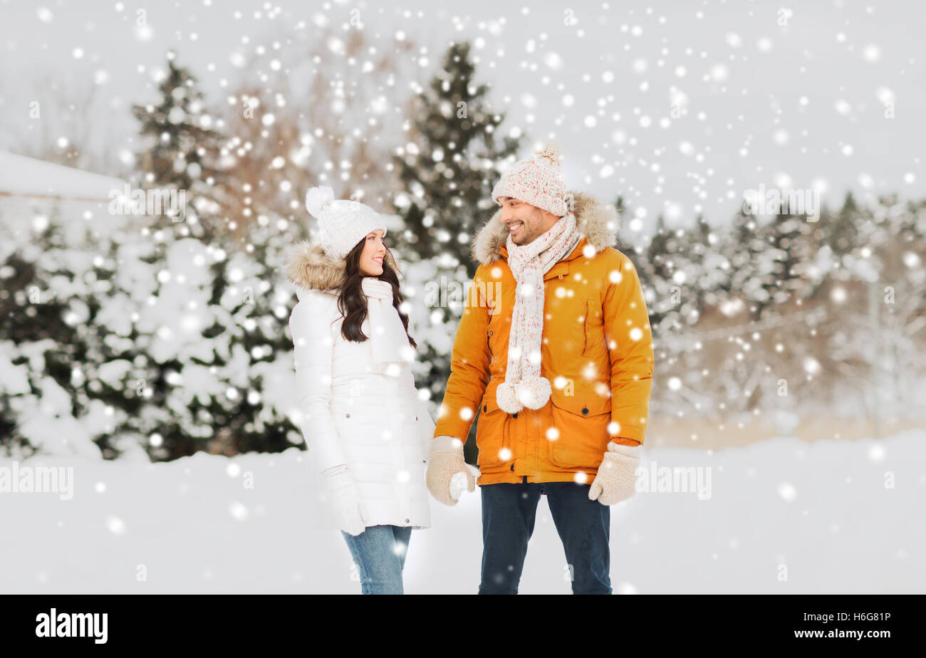 happy couple walking over winter background Stock Photo - Alamy