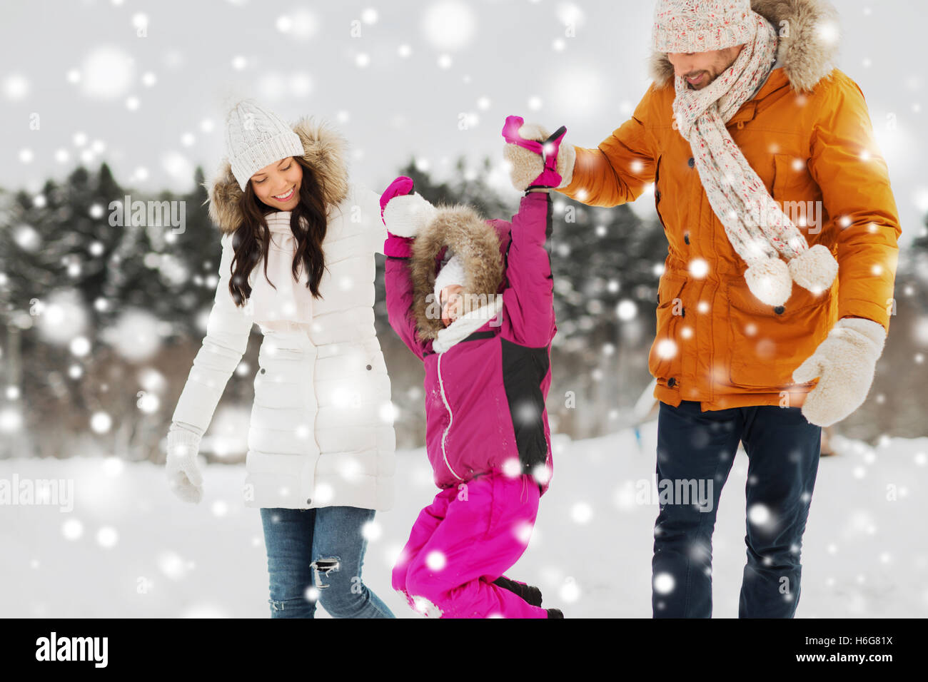happy family in winter clothes walking outdoors Stock Photo - Alamy