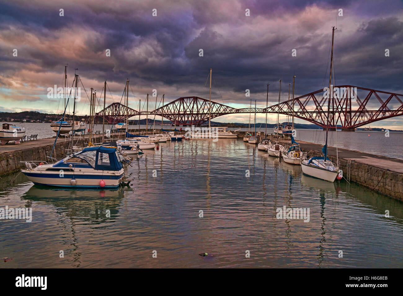 Forth Railway Bridge from old harbour, sunset, South Queensferry, west lothian, Edinburgh, Scotland, UK Stock Photo