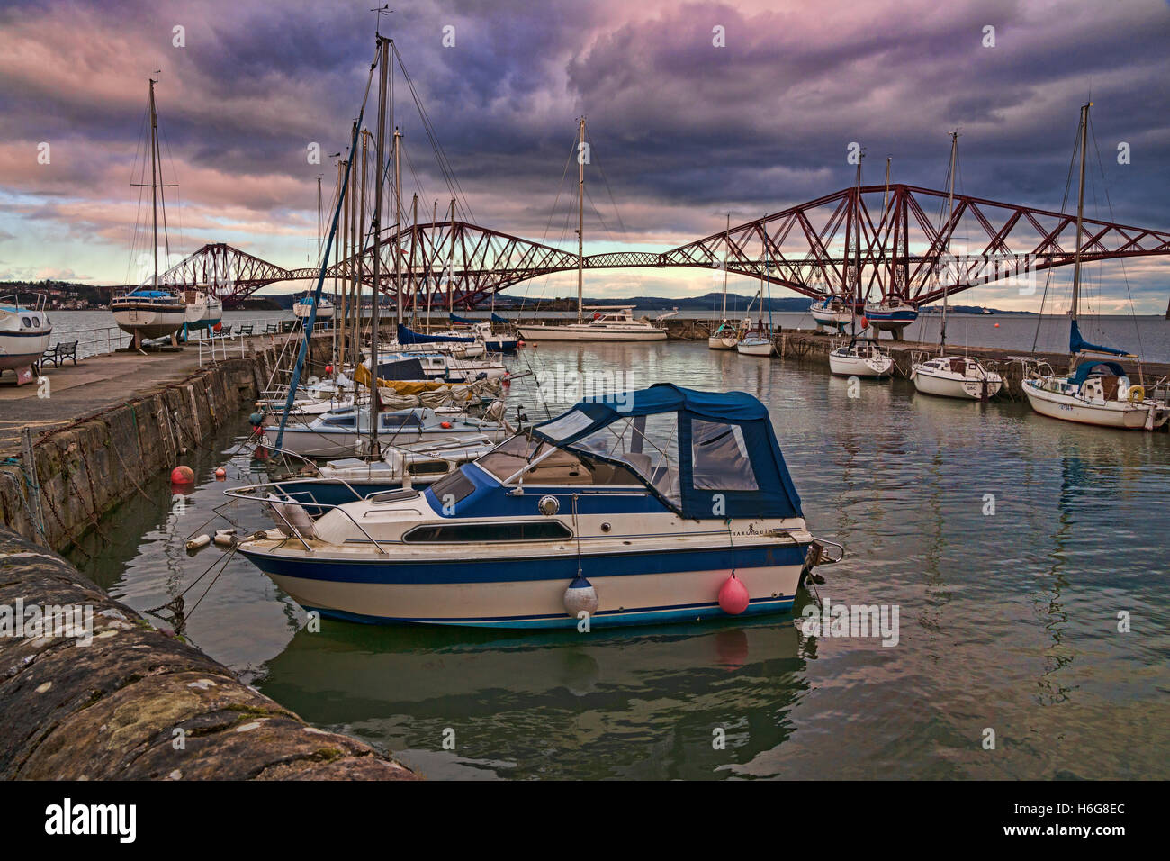 Forth Railway Bridge from old harbour, sunset, South Queensferry, west lothian, Edinburgh, Scotland, UK Stock Photo