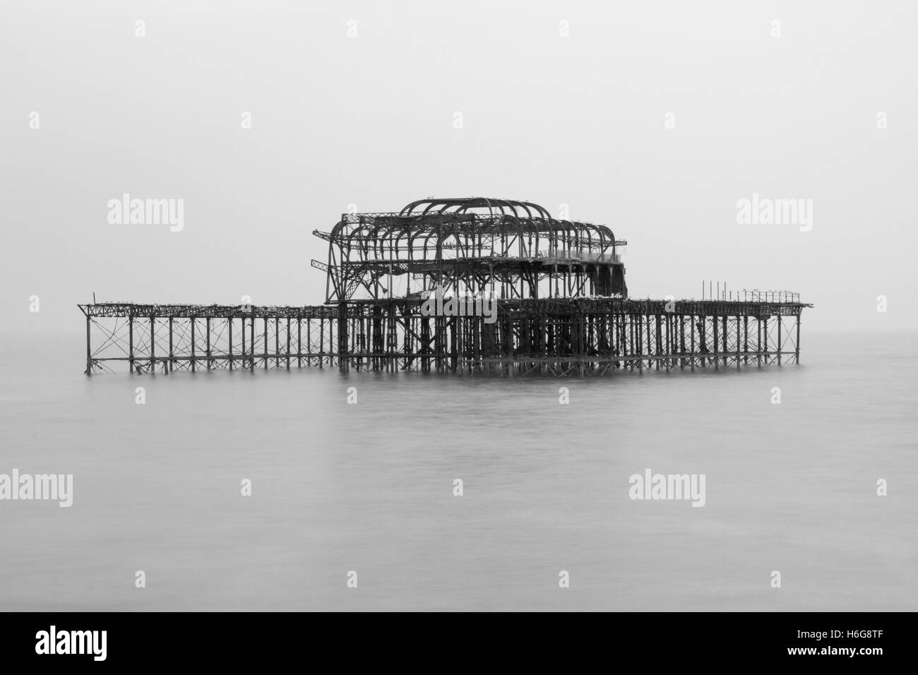 Black and white photograph of the remains of the west pier in Brighton Sussex United Kingdom Stock Photo
