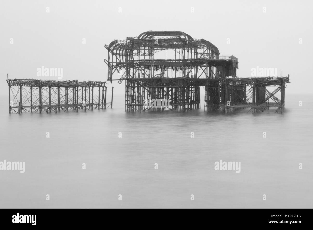 Black and white photograph of the remains of the west pier in Brighton Sussex United Kingdom Stock Photo