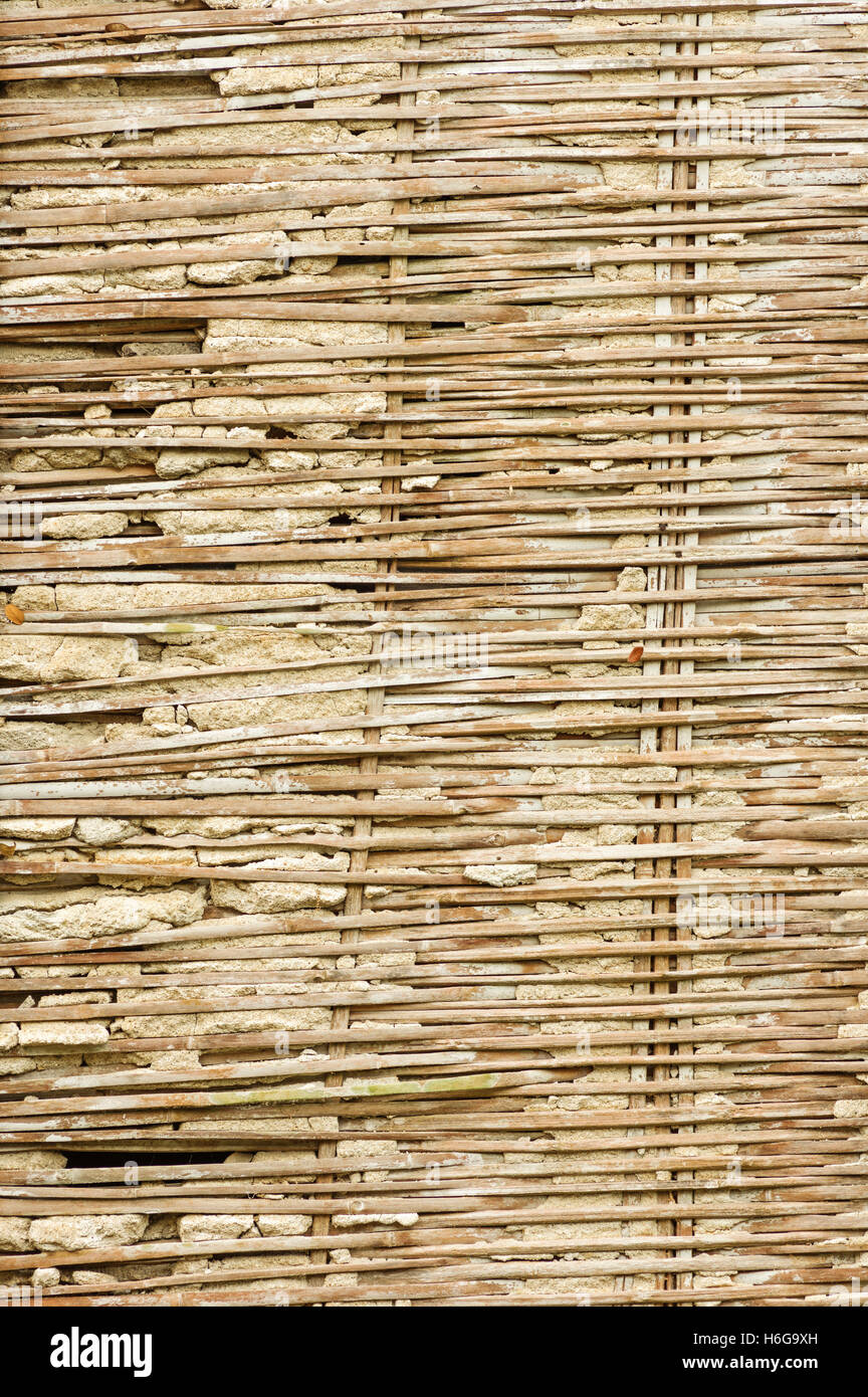 old broken bamboo lath and plaster wall in rural Thailand Stock Photo