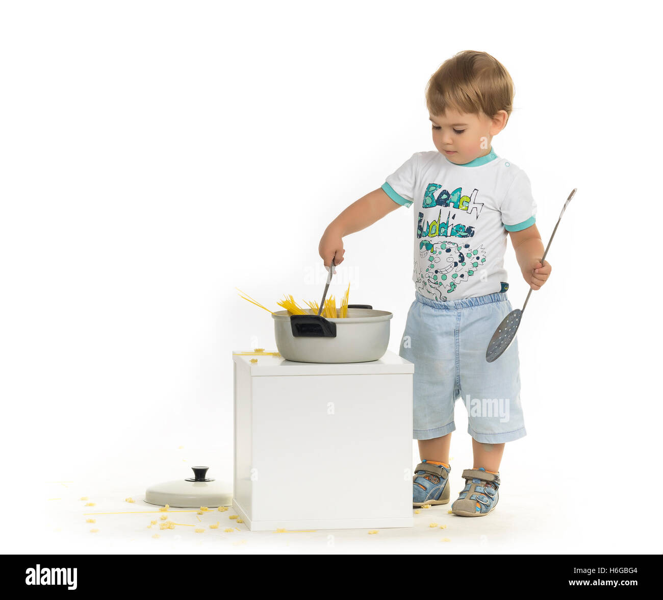 Two years boy learning cooking through playing. Stock Photo