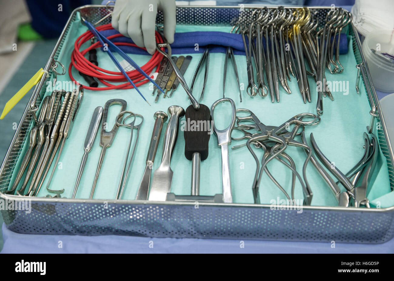 Surgical instruments,clamps,scalpels and scissors laid out in a tray in the operating theatre Stock Photo