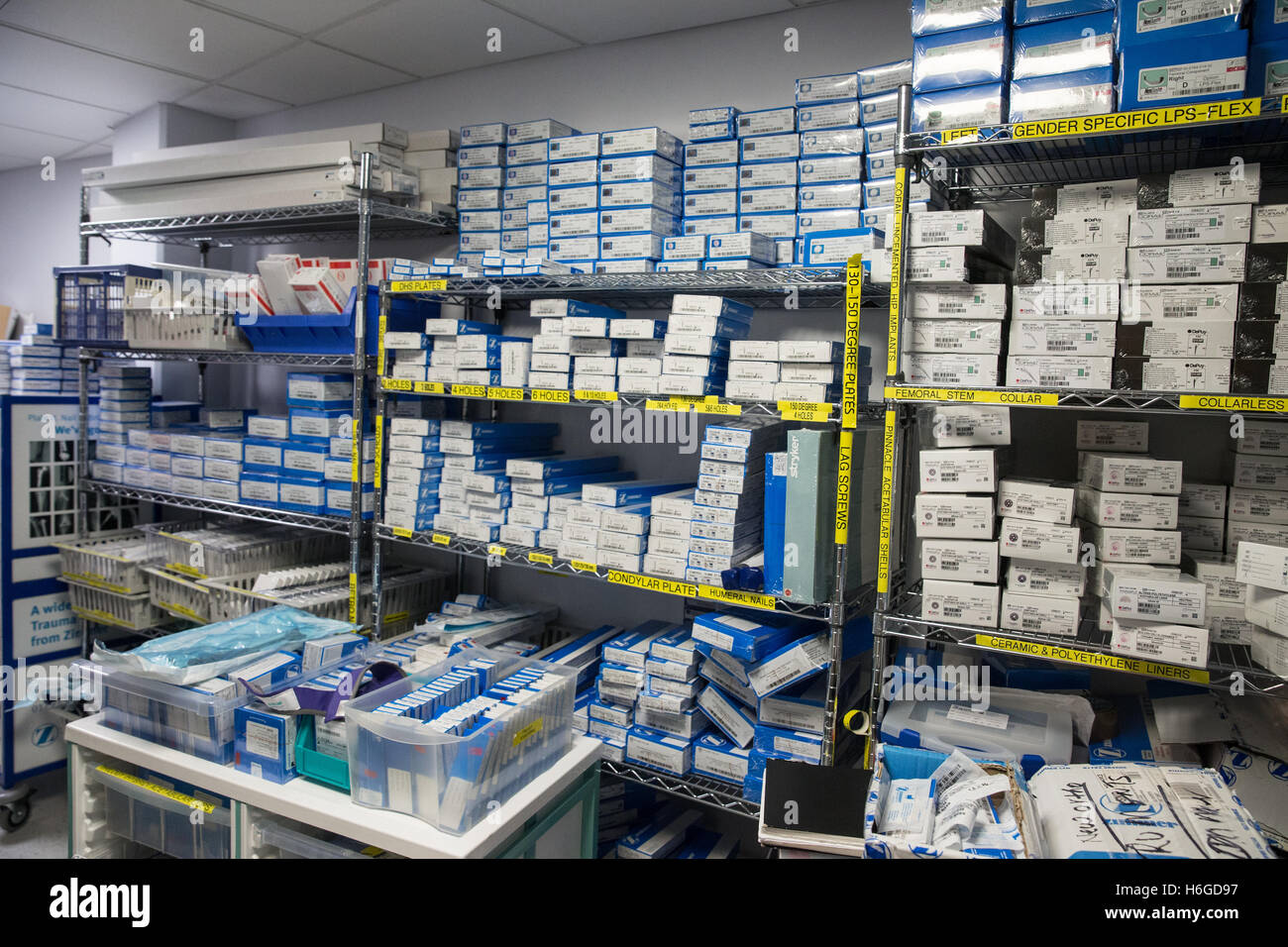 Storeroom in a hospital with medical equipment including hip replacement sterile packs Stock Photo