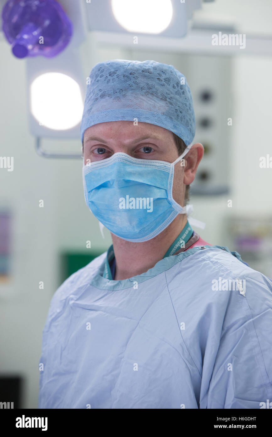 A surgeon wearing a mask in an operating theatre of a hospital Stock Photo