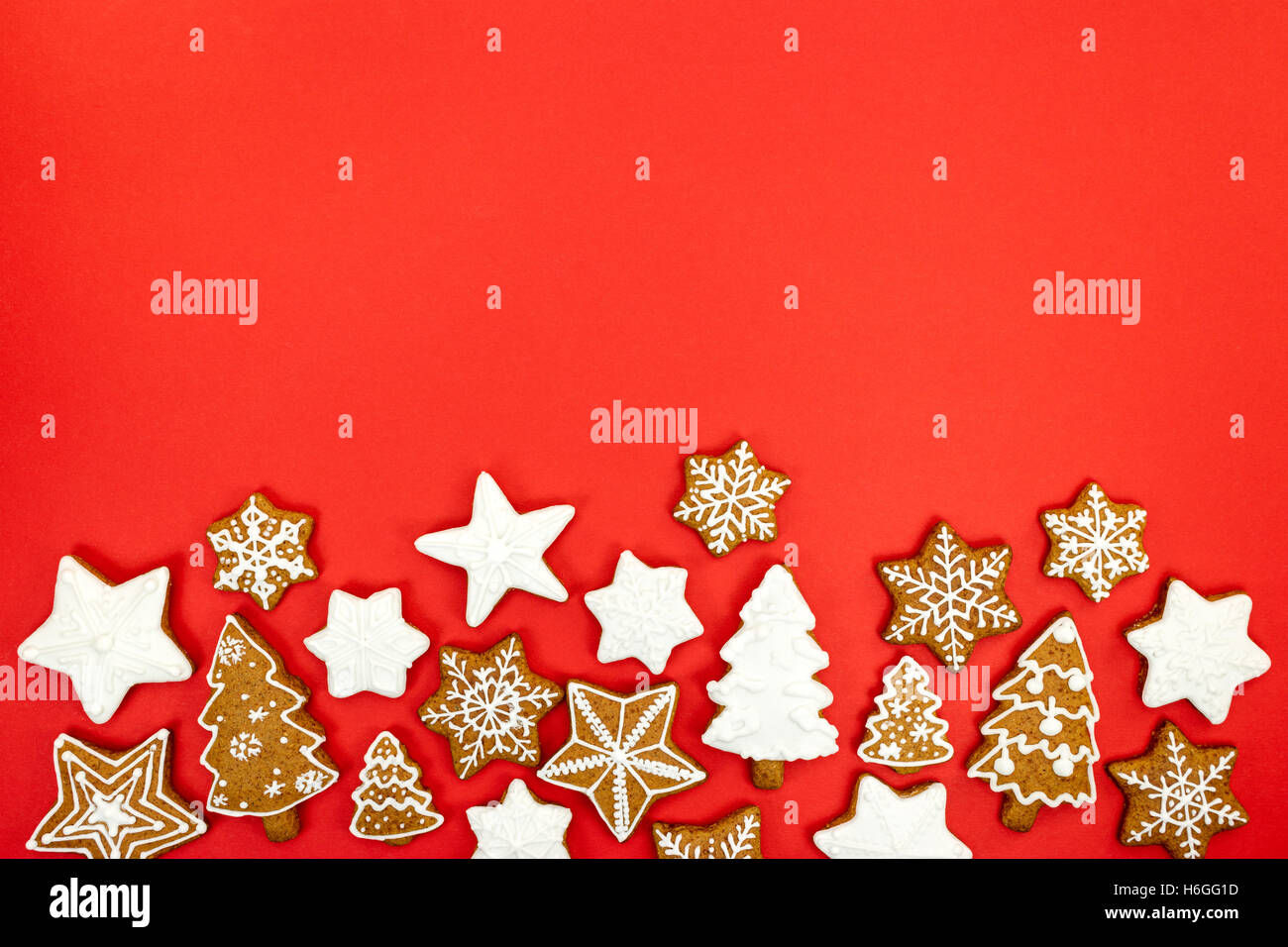 red background with homemade various shaped christmas gingerbread ...
