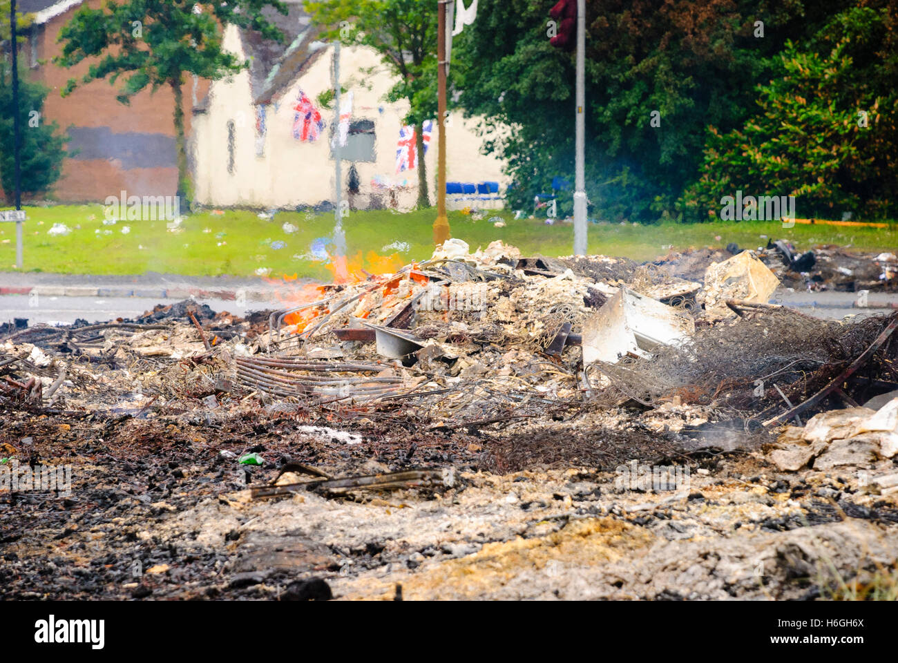 Remains of an 11th night bonfire on the morning of the 12th July.  Bonfires are traditionally lit by the Protestant Community on the 11th July to commemorate the Battle of The Boyne in 1690, during which, bonfires were lit to serve as beacons to warn troops that the battle was beginning. Stock Photo