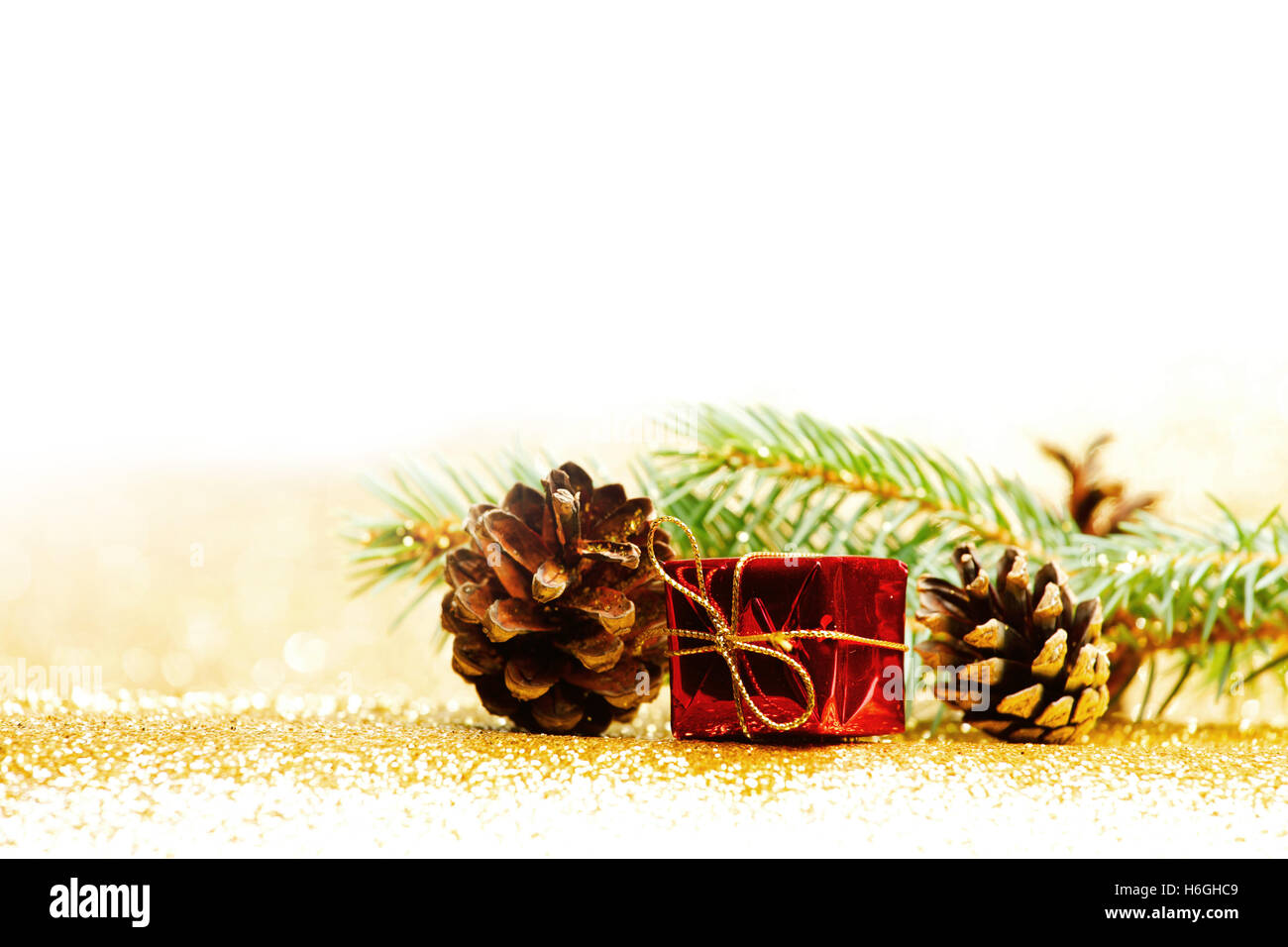 Christmas card with fir branch and decorations on golden gitter ...