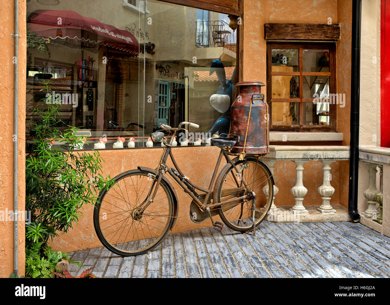 French boutique cafe and an Old bicycle with milk churn parked outside France Europe Stock Photo