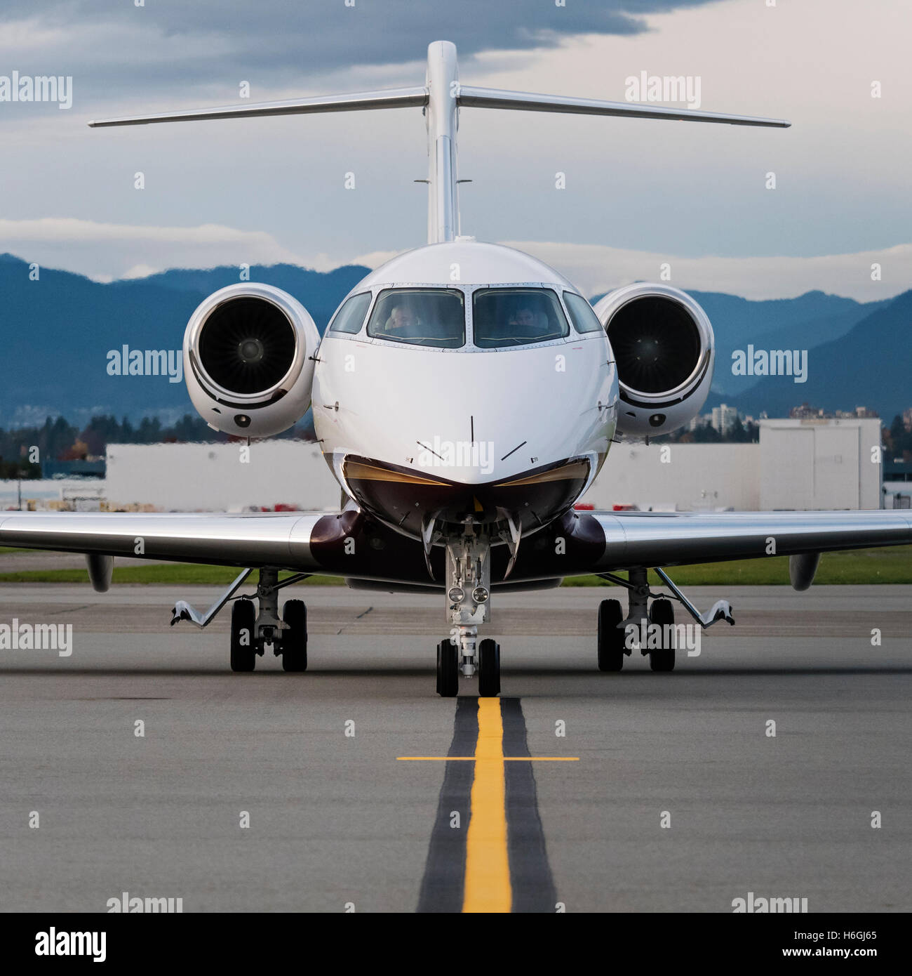 A Bombardier Challenger 300 N166WC business jet waits to clear customs, south terminal, Vancouver International Airport, Canada Stock Photo