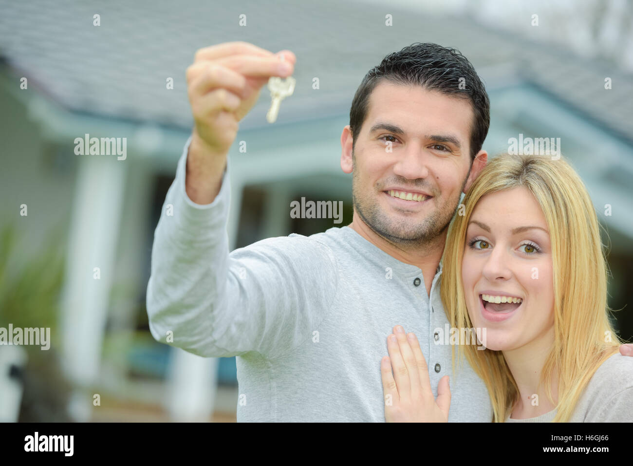 Couple holding keys to their new house Stock Photo - Alamy