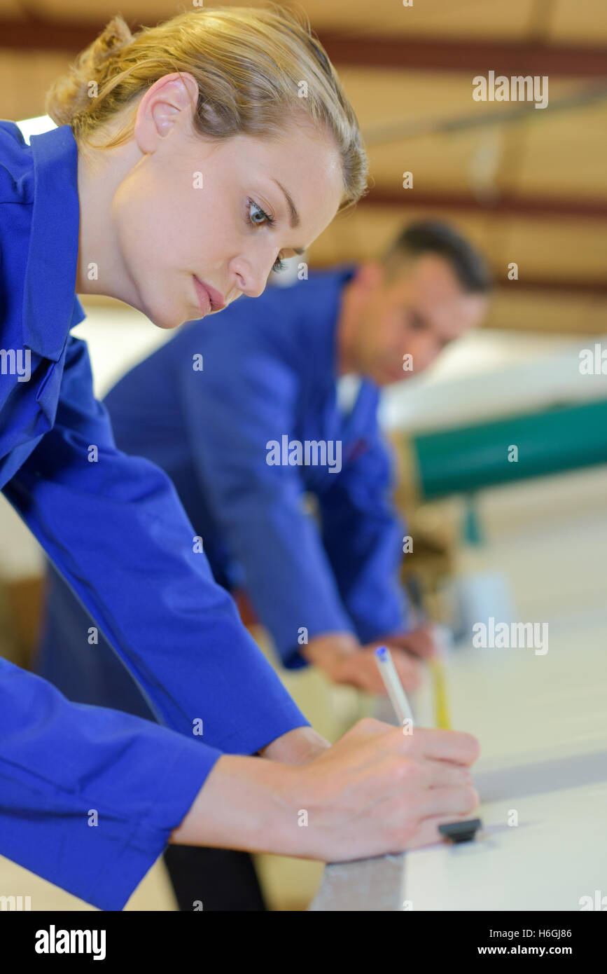 Woman marking place on textiles Stock Photo Alamy