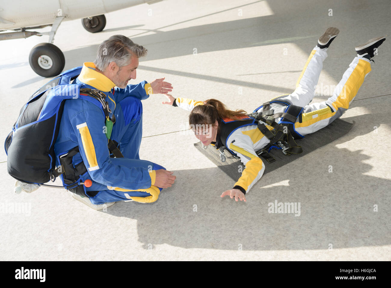 Woman practicing skydiving posture Stock Photo