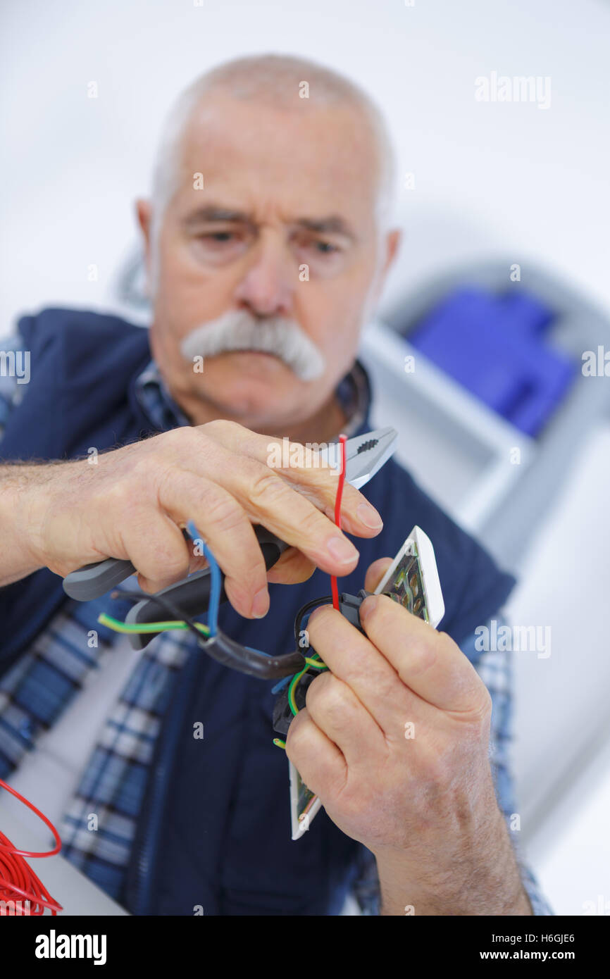 renovation light switch and plug socket on wall hand Stock Photo Alamy