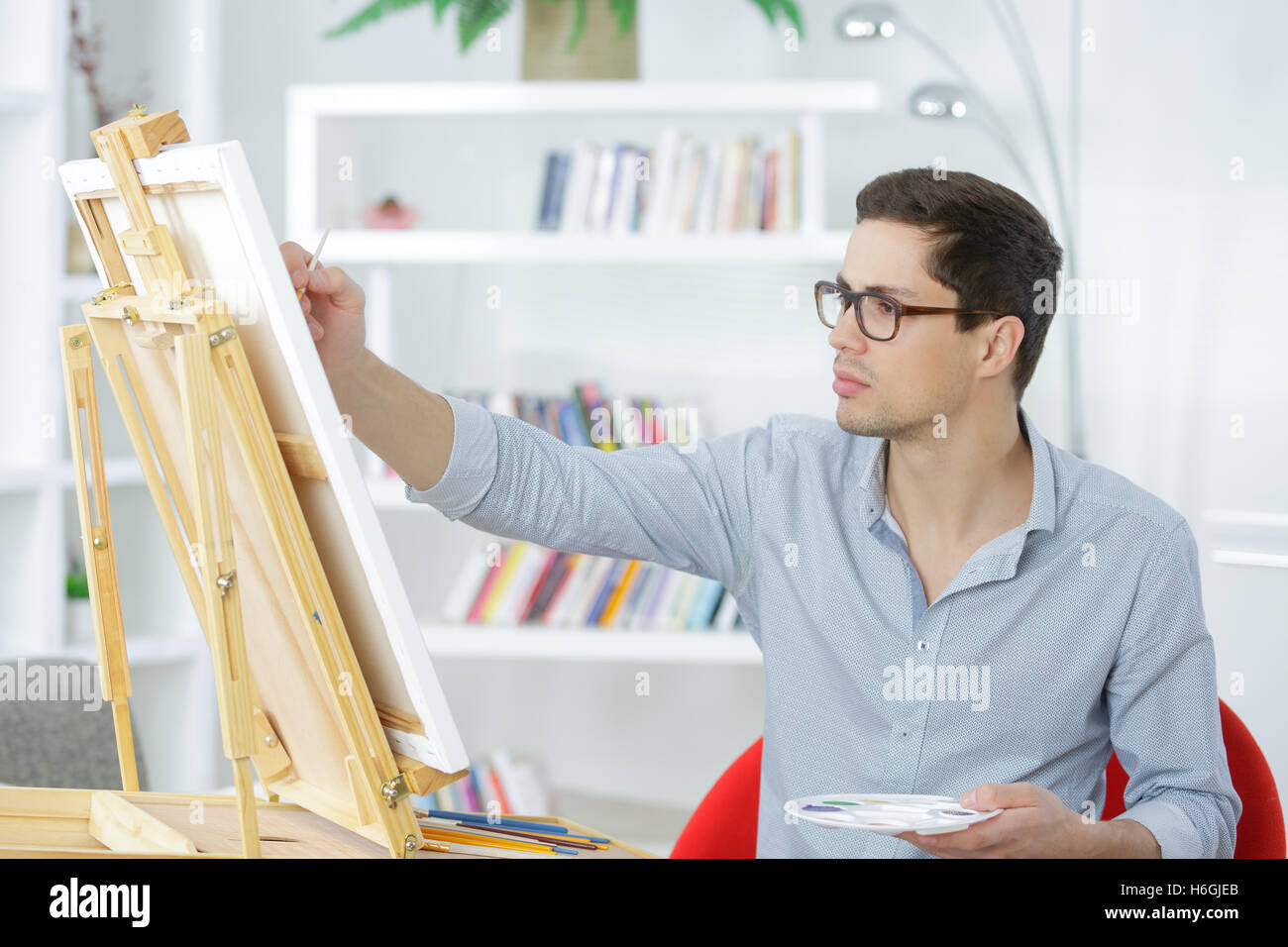 young painter drawing on a canvas Stock Photo Alamy