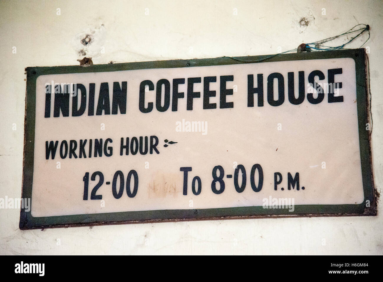 Working hour sign board on Indian Coffee House building at College