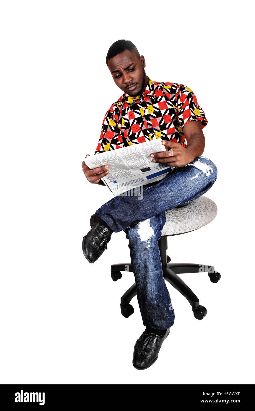 A handsome black man sitting on a chair, his legs crossed and reading the  news paper for white background Stock Photo - Alamy