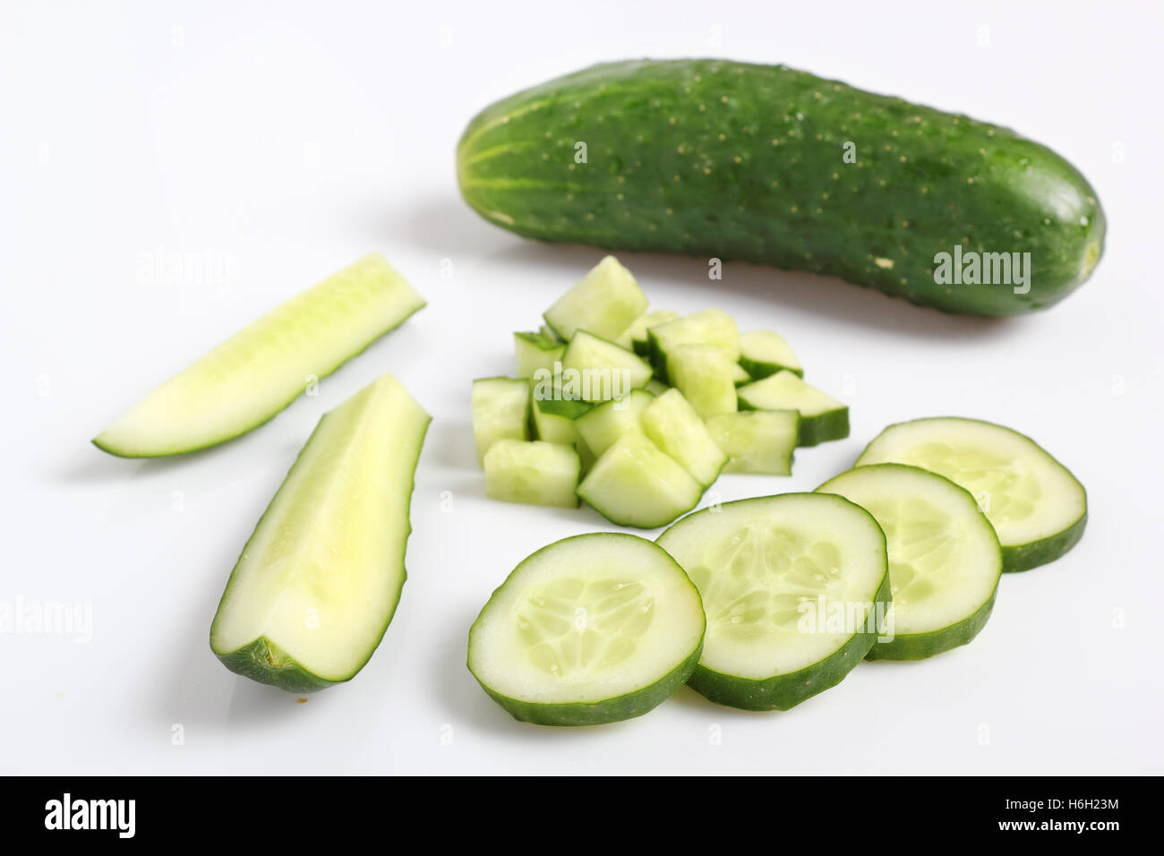 Slicied and diced cucumbers. Isolated on a white background. Stock Photo