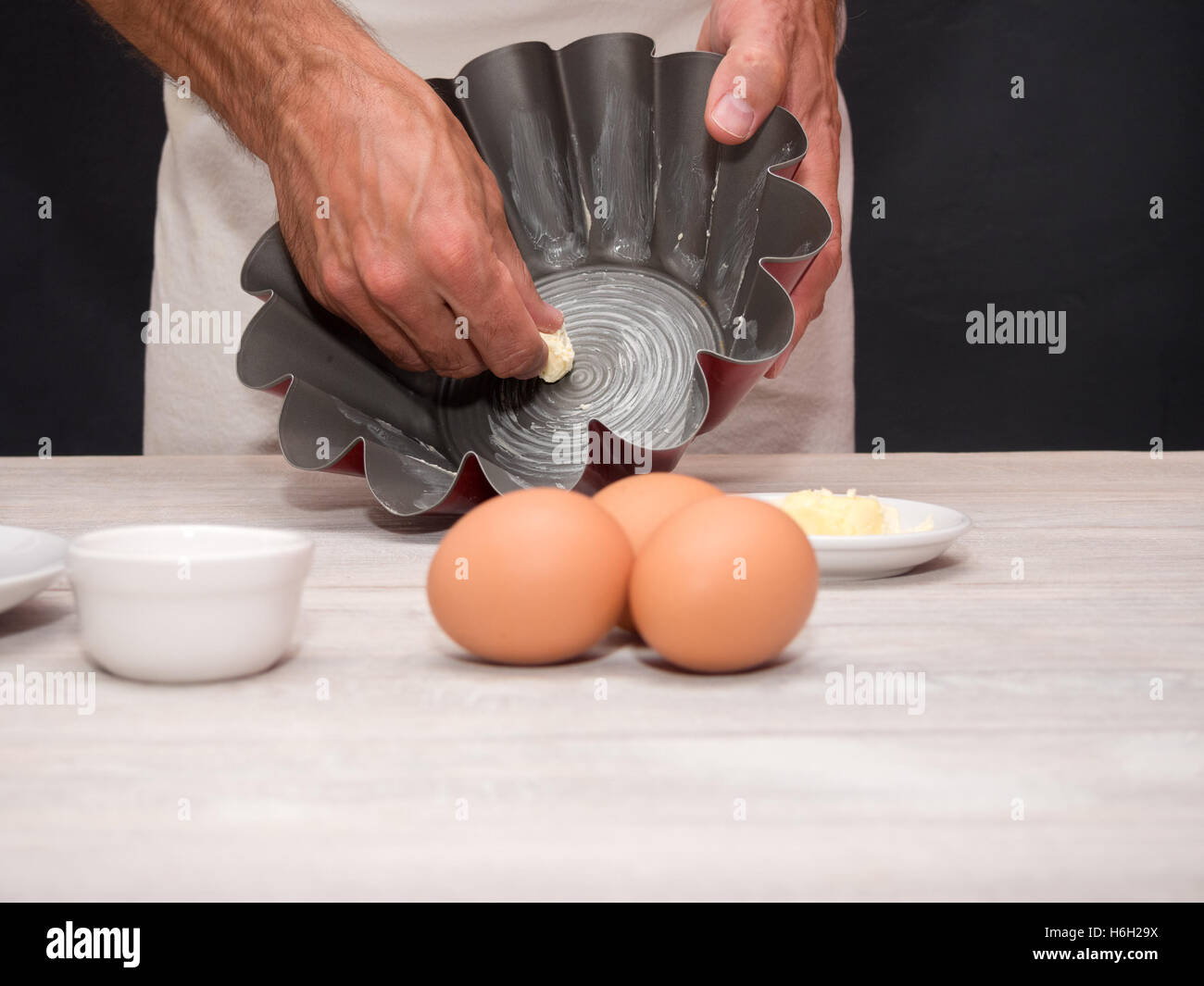 Greasing pan with butter. Making Yogurt Cake. Stock Photo
