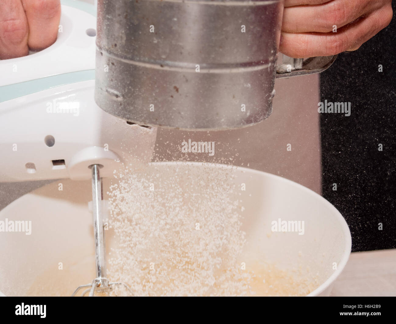 Sifting flour. Making Yogurt Cake Stock Photo Alamy