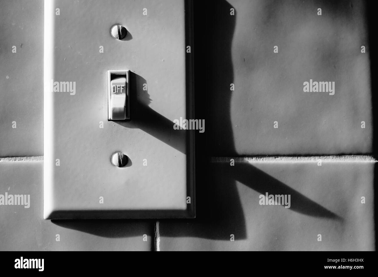 Light switch on tile ceramics wall turned off Stock Photo