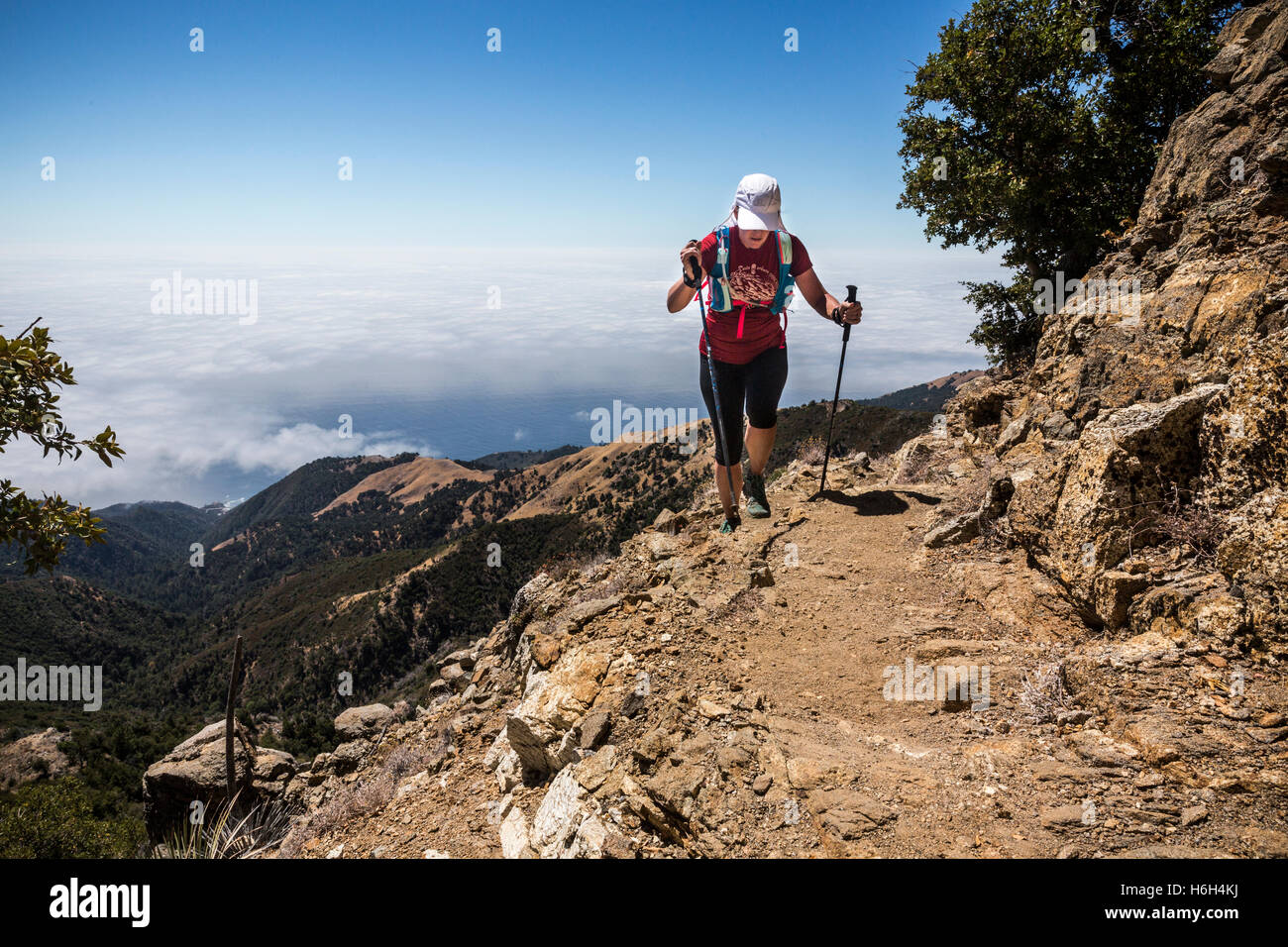 A hiker descending down the trail from Cone Peak along the Big Sur Coast in California. Stock Photo