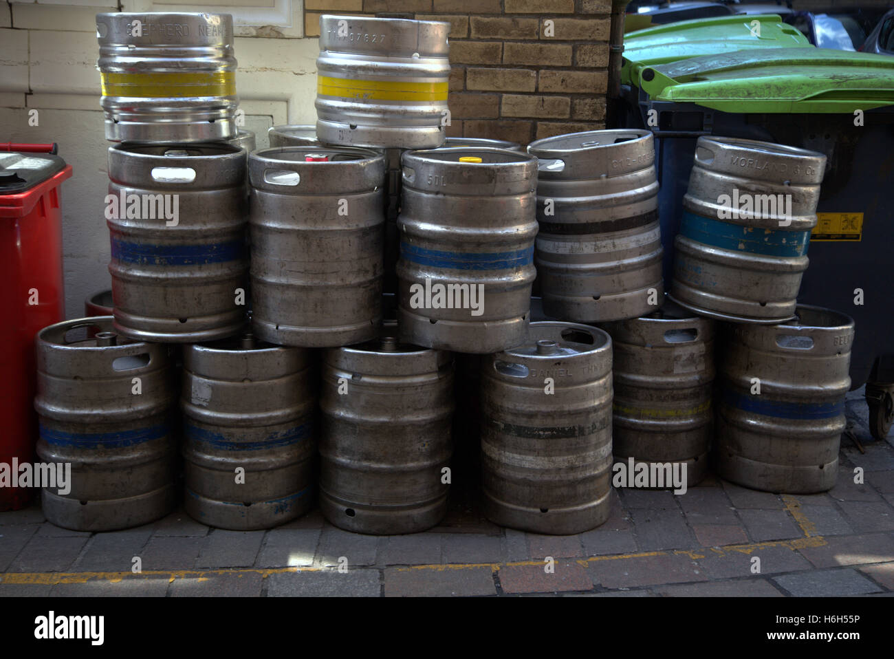 beer kegs stacked in alley for collection Stock Photo