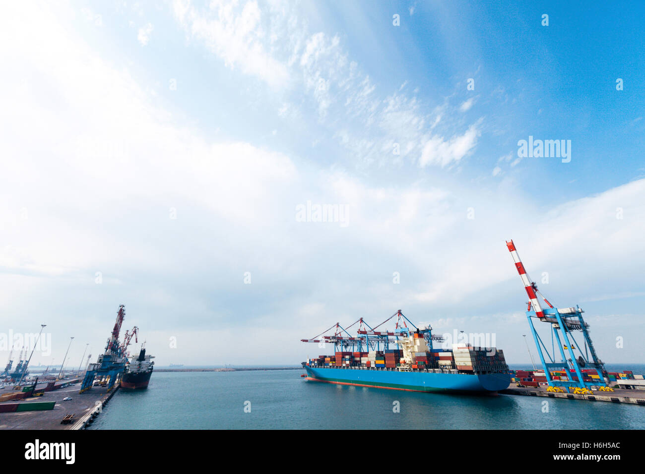 A freighter docking in a commercial harbor, as seen from the bridge of ...