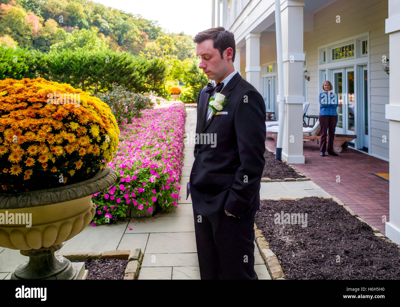 Proud mother watching groom preparing for wedding photographs; Omni Bedford Springs Resort & Spa; Bedford; Pennsylvania; USA Stock Photo